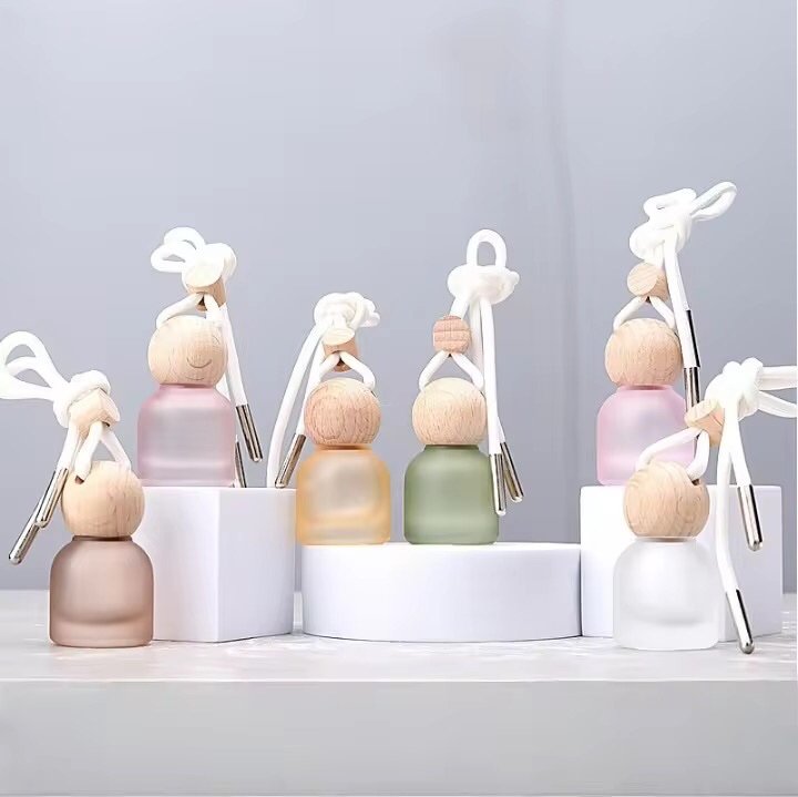 Handmade car air freshener with colorful glass bottle hanging from vehicle rearview mirror