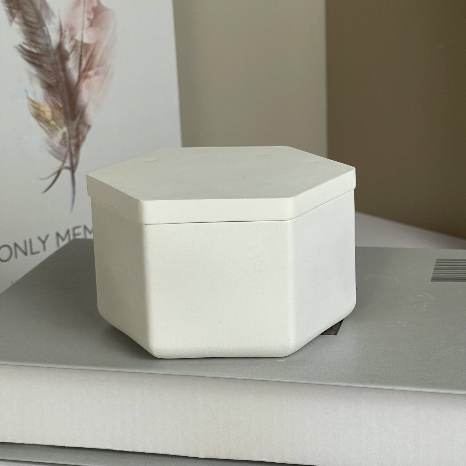 White hexagonal candle vessel displayed in contemporary home interior
