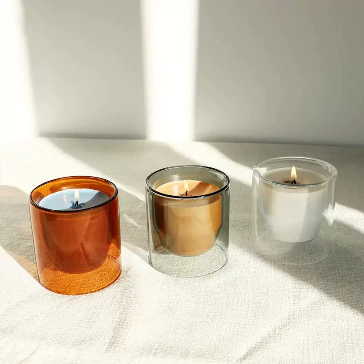 Multi-color display of double wall glass candle vessels (red, teal, clear) with dimension chart showing perfect 200ml size.