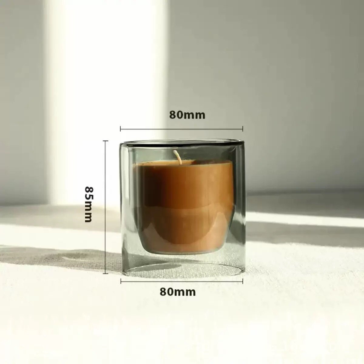 Sophisticated teal colored glass candle cup with double-layer design, highlighting clarity and modern decorative appeal.