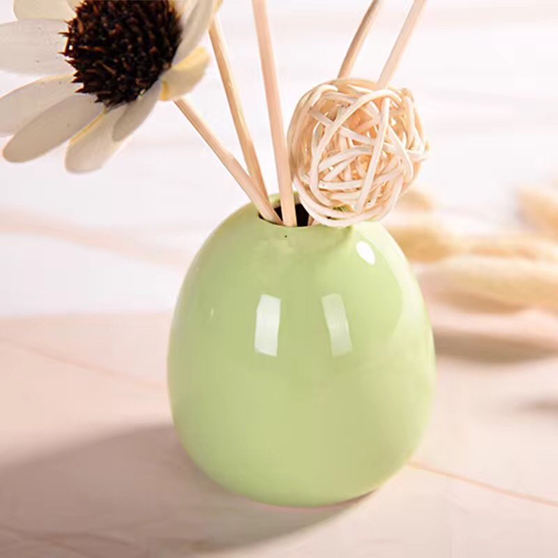 Ceramic European style diffuser bottle in fern green finish, showing elegant curvature and 1.8cm opening for reed sticks