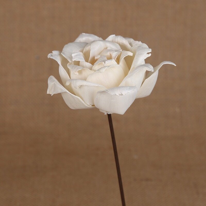 Side profile view of artificial rose demonstrating dimensional flower structure