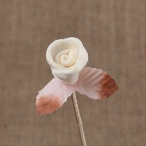 Close-up detail of miniature paper rose bud, highlighting realistic curling petals and flexible vine for reed diffusers.