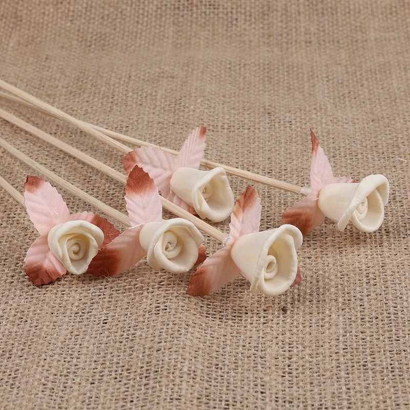 Flat lay composition of handmade paper roses, emphasizing perfect 3cm size and natural vine stem quality.