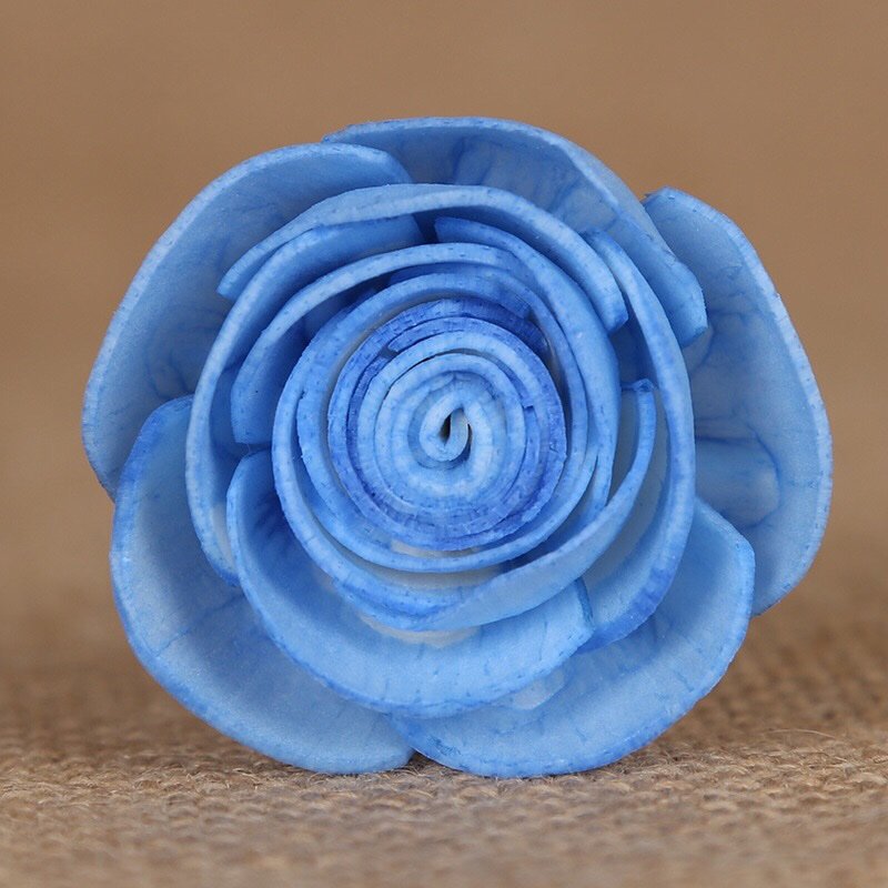 Vibrant blue paper rose macro shot highlighting layered petals and multiple mounting choices for floral arrangements