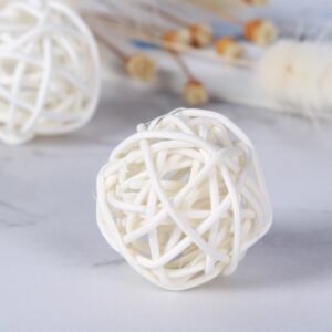 Close-up of 3cm white rattan ball showing intricate woven texture and natural vine stem attachment