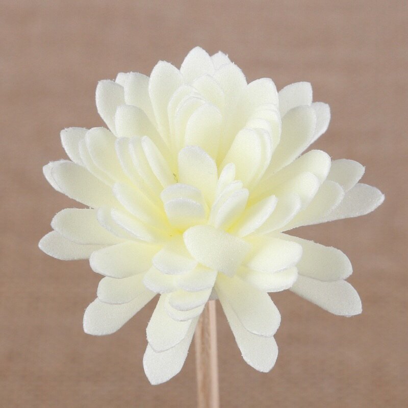 Close-up side view of handmade chrysanthemum bloom highlighting dimensional form and stem attachment points