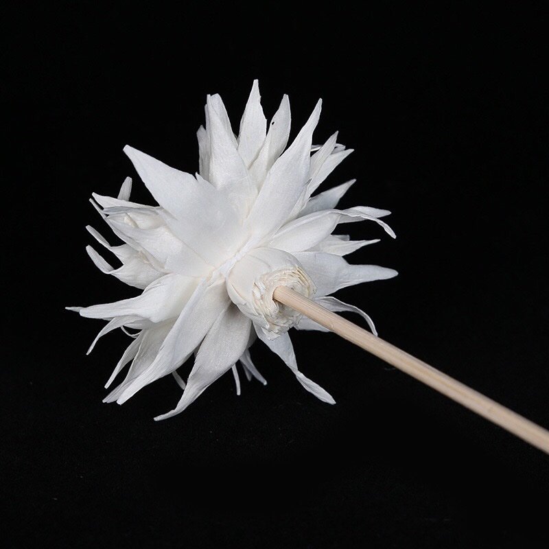 Close-up side view of handmade flame-style bloom highlighting curled petal edges and organic shape