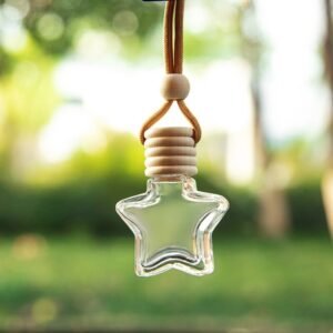 A clear star-shaped glass car perfume bottle with a light wooden lid and hanging cord, isolated on a white background.
