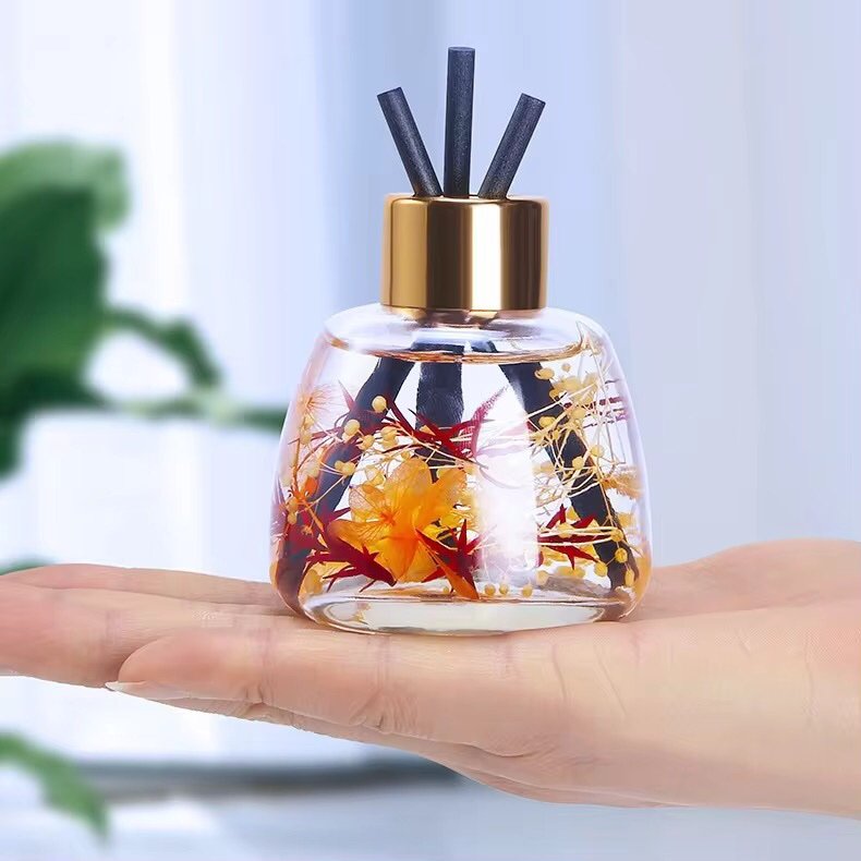 Close-up of the 100ml apple bottle, highlighting the gold lid and glass stem detail.