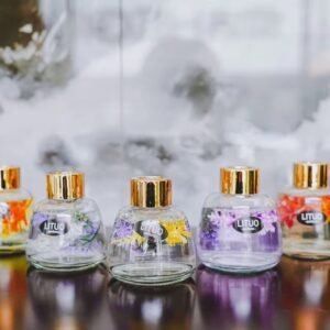 Both sized bottles styled together on a shelf with other kitchen or home decor items.