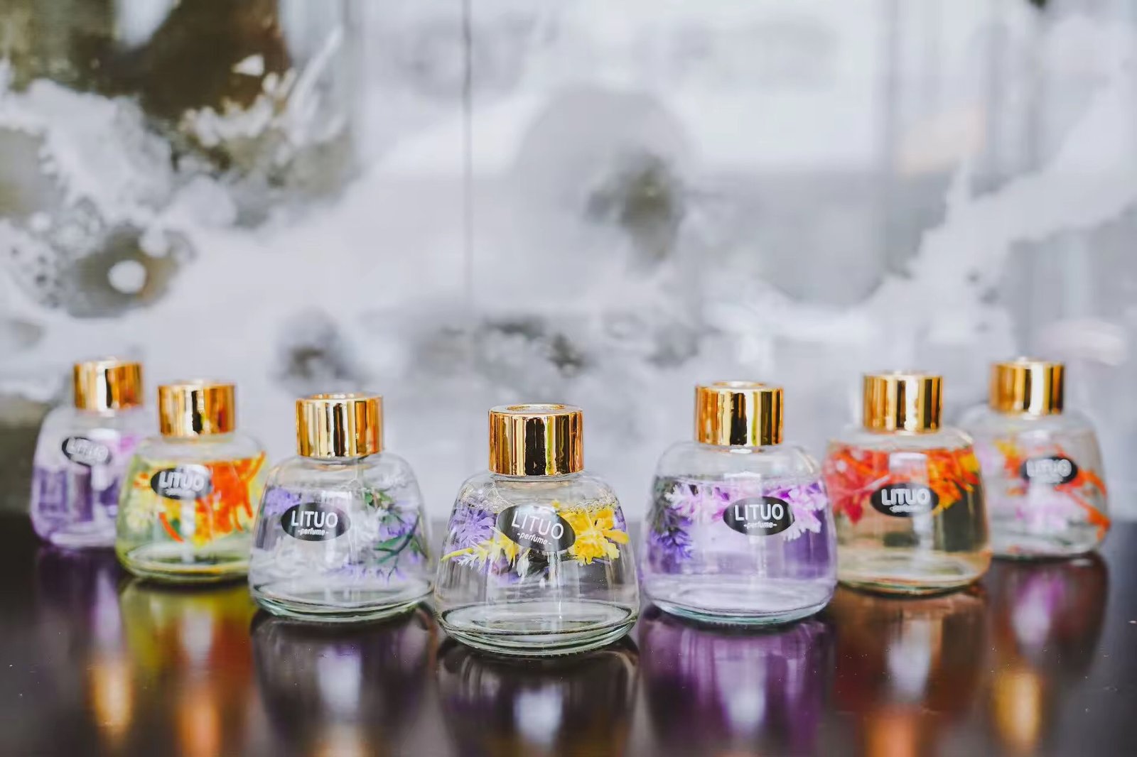 Both sized bottles styled together on a shelf with other kitchen or home decor items.