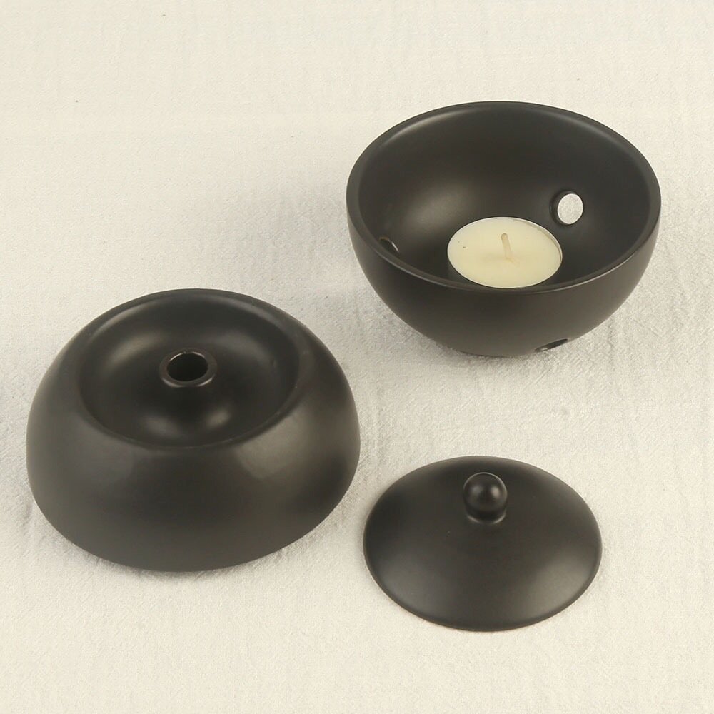 Ceramic oil burner size: 10x10x10cm, 400g weight, 30ml oil capacity with tea light compartment.
