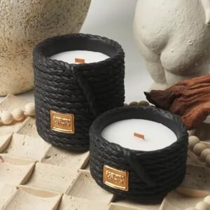 Three cement candle jars in retro black colors displayed on a wooden shelf with dried flowers – Nordic minimalist interior styling