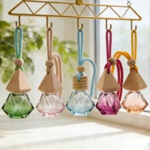 Five wooden lid car perfume pendants in different colors, hanging on a rearview mirror – real‑life use scenario