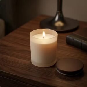 9oz frosted beige candle jar with a lit candle inside – warm glow, heat resistant glass, elegant home decor piece
