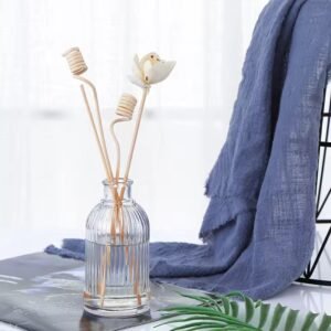 Clear reed diffuser glass bottle with dried flowers and rattan sticks – natural home fragrance setup