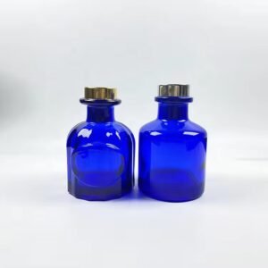 Two custom clear blue 50ml aromatherapy bottles side by side – showing rich transparent blue color, glossy finish