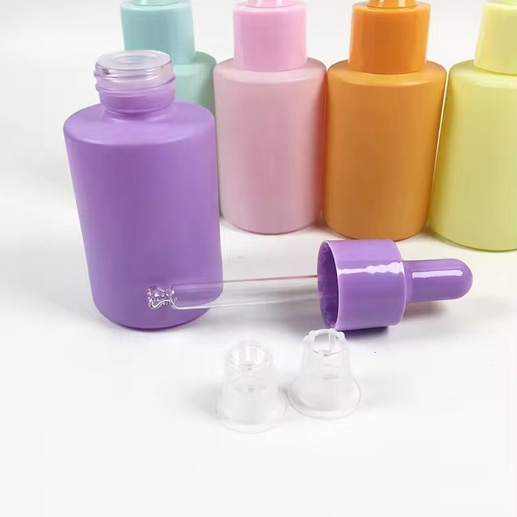 Wide desktop display of 30ml solid color essential oil bottles with droppers – full spectrum of colors, natural lighting
