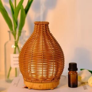 Rattan diffuser emitting cool mist – soft steam rising from the top, placed on a wooden table, cozy ambiance