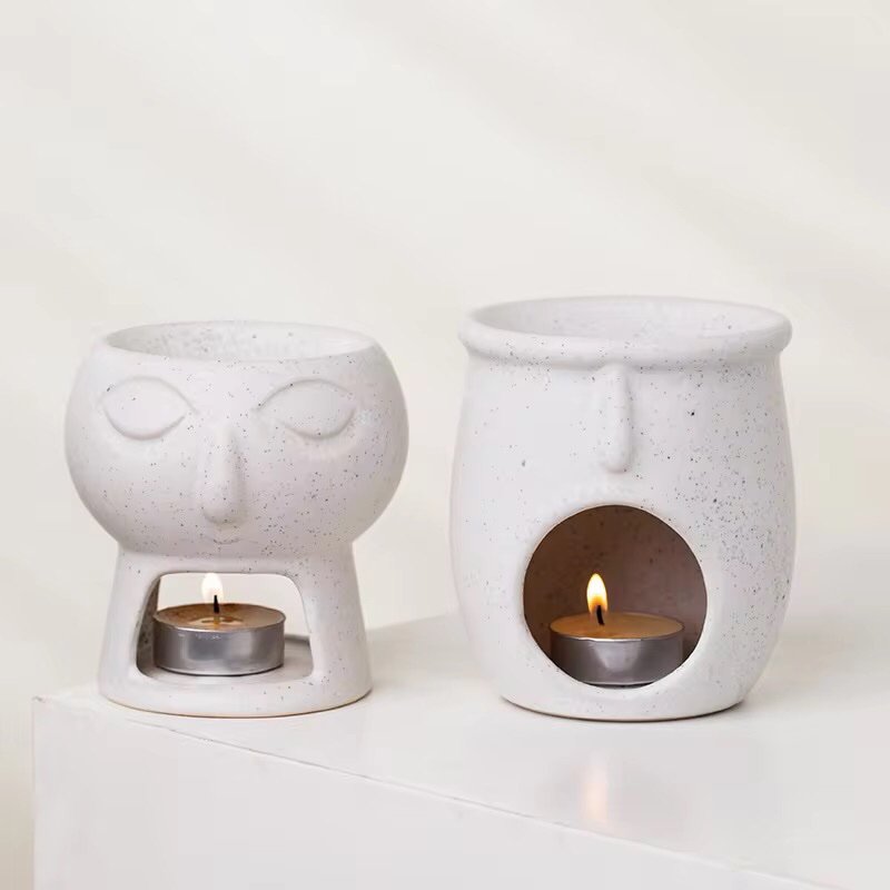 Alternative angle of two sculptural ceramic wax burners – organic curves, modern art object