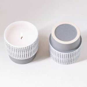 Top-down view of lit candle jar next to bottom detail – showing open rim and unglazed base, contrast