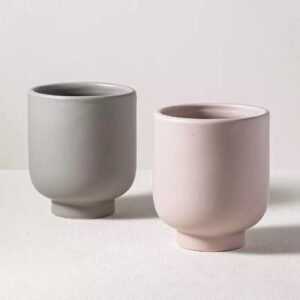 Pink and gray ceramic candle jars standing together – side by side, clean minimalist design