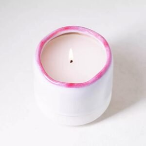Top‑down view of the jar with candle – red rim encircling the wax pool, creating a flower‑like shape