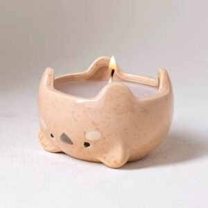 Kawaii cat-shaped ceramic candle jar with lit candle – warm glow, cute face details